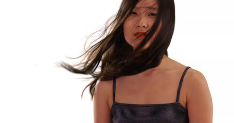 Naklejka premium Close view of millennial woman with hair blowing in her face isolated on white