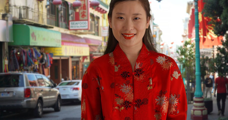 Close up of Asian millennial in traditional Chinese outfit in China Town