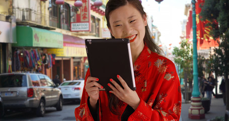 Close up of millennial woman video chatting with tablet in San Francisco