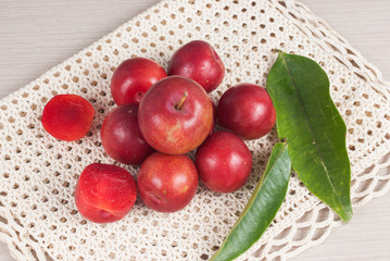 red plum on the wooden background