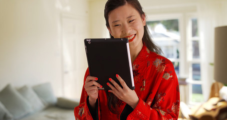 Close up of millennial woman video chatting with tablet from apartment home
