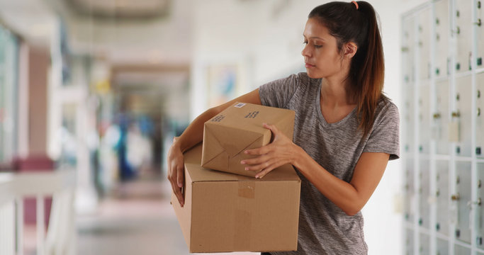 Beautiful Caucasian woman at post office with cardboard packages