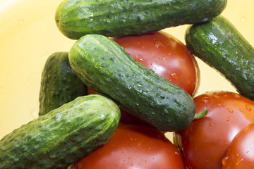 tomato and cucumber on a plastic bowl