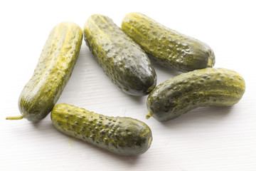 salted cucumber on white table