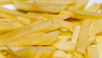 raw french fries on a white plate