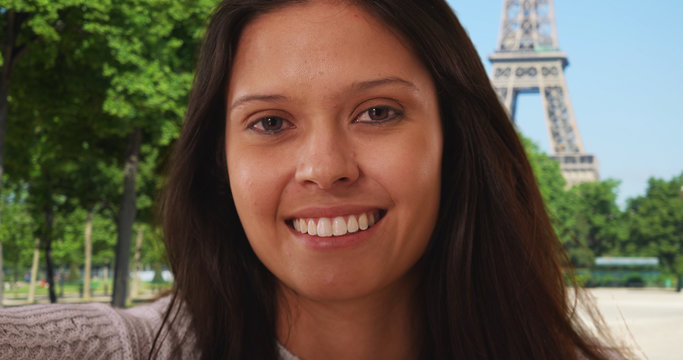 POV of millennial woman in Paris taking phone selfie near Eiffel Tower