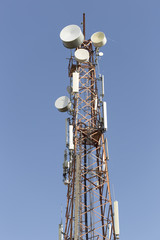 Telecommunication tower on blue sky clouds background,Tower poles and wireless telephone antennas