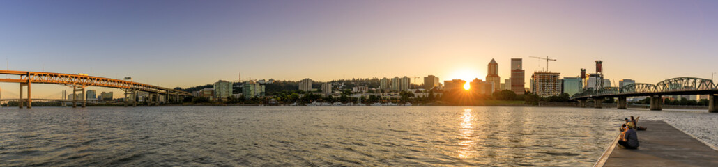 Sunset over Portland downtown waterfront city skyline along Willamette River by Hawthorne Bridge