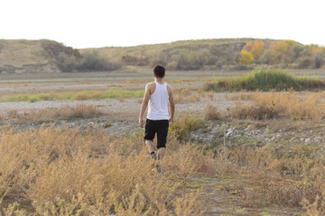 a young man walks in dirty, salty ecological places