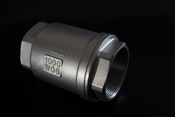 Stainless steel check valve on black background