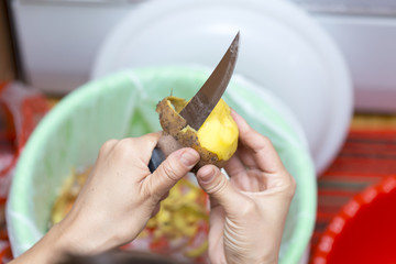 the girl is cleaning potatoes