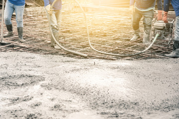 Workers man using a Vibration Machine for eliminate bubbles in concrete. after Pouring ready-mixed...