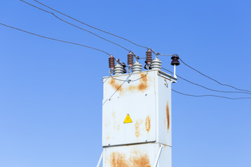 Electrical transformer against the blue sky background