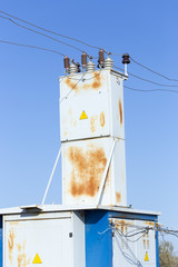 Electrical transformer against the blue sky background