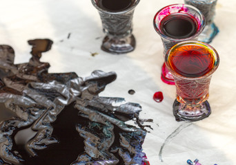 colored paints on a glass beaker