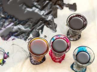 colored paints on a glass beaker