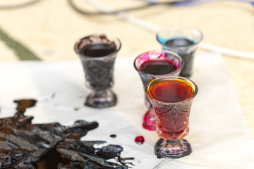 colored paints on a glass beaker