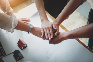 business people putting their hands together. Friends with stack of hands showing unity and teamwork