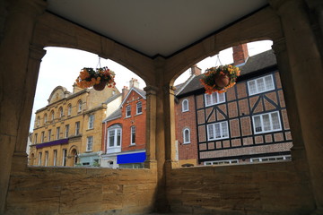 Fototapeta na wymiar Buildings in main street seen through windows of an old Market House in Ilminster, Somerset