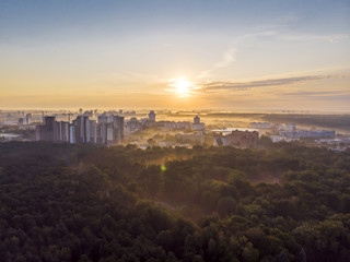 urban summer landscape in early morning with rising sun