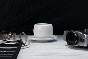 on the director's desk is an old video camera with a film on the back of a black background, there is a place for an inscription