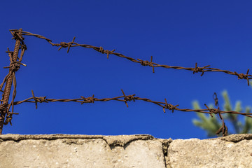 barbed wire on blue sky background