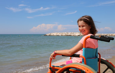 Obraz na płótnie Canvas little girl on the wheelchair on summer