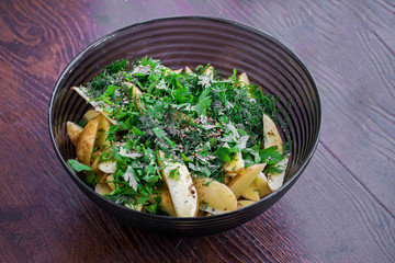 Process of cooking baked potatoes. Fragrantly soaked in spices and sauce, fresh potatoes with peel. The potato is ready to go to the oven. Potato with chili, garlic and spices.