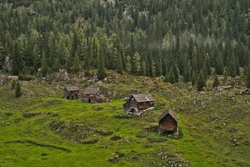 Traditional wooden shepherd huts on high alpine meadow in slovenian part of Julian Alps