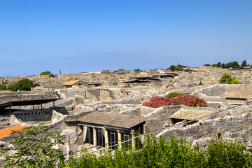 View of the historical antique ruin of the city Pompei. There are roofs of houses and stones houses. It is situated in Italy in Europe.