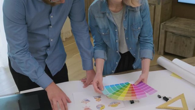Graphic designers choosing a color for logo design