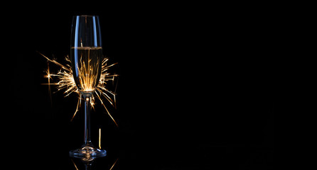 Fototapeta na wymiar Tall glass of champagne with Bengal lights