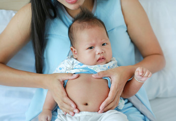 Mother take care infant with pain in her Stomach.