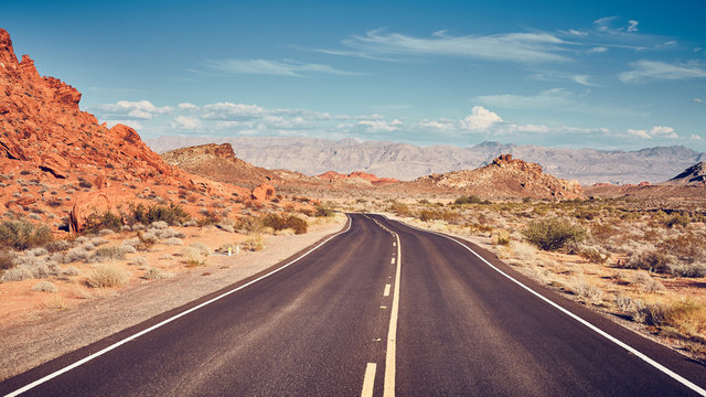 Retro stylized picture of a desert road, travel concept.