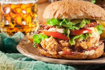 Chickenburger with bacon, tomato, cheese and lettuce