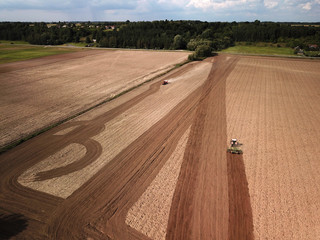 Fototapeta premium Aerial view of tractor on agricultural field
