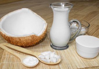 Coconut in cosmetology. Сream, balm, coconut milk. Skin, body and face care. Cosmetology. Nutrition and hydration. Homemade coconut products. Wooden spoons with coconut pulp and in powder.
