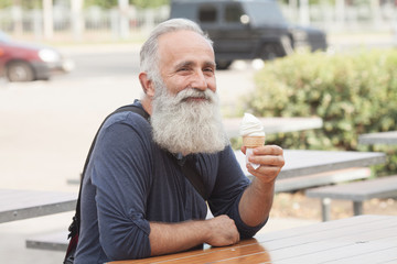 Happy Senior man eating ice cream cone