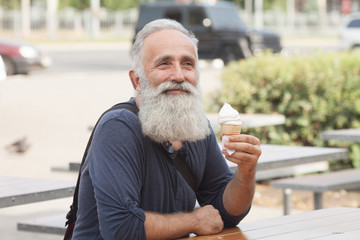 Happy Senior man eating ice cream cone