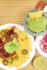 Overhead photo of Mexican nachos with guacamole and copyspace