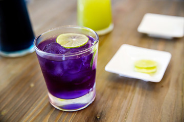 Welcome drink, butterfly pea flower juice with lemon slice. natural base test indicator,science at home concept. amazing colorful drinking. image for background, copy space and menu list.