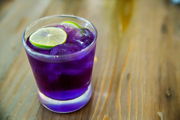Welcome drink, butterfly pea flower juice with lemon slice. natural base test indicator,science at home concept. amazing colorful drinking. image for background, copy space and menu list.