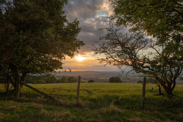 Beautiful dramatic Summer sunset landscape over English countryside with stunning light