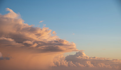Beautiful cumulonimbus stormy rain cloud formations in Summer sunset sky with dramatic moody color and texture