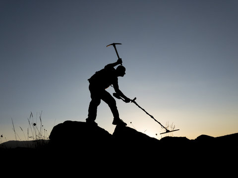 A Treasure Hunter With Metal Detector On Sunset