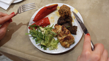A first person view and a point of viewing a woman who eats pepper and vegetables.