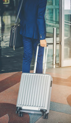 Businessmen leave with baggage at the airport.