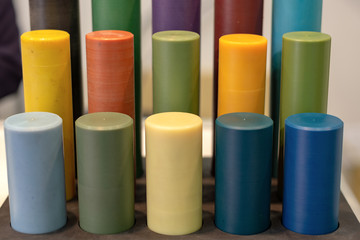Multicolored plastic cylinders. Sample of manufactured chemical production