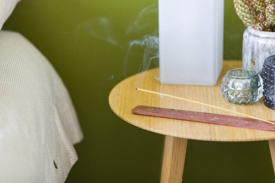 Incense Burning on Bedside Table Before Meditation