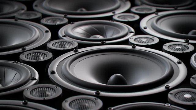 Vibrating speaker membranes stacked in endless loop. Lit by studio lights. 4K HD